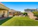 Backyard features artificial turf, outdoor seating, fire pit, and covered patio at 3042 Echoed Rondel Ln, Henderson, NV 89044