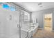 Bright bathroom with a separate glass-enclosed shower and soaking tub at 3042 Echoed Rondel Ln, Henderson, NV 89044