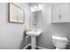 Cozy bathroom with a pedestal sink, framed artwork, and a neutral color palette at 3042 Echoed Rondel Ln, Henderson, NV 89044