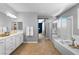 Bathroom showcasing double sinks, a separate shower and a soaking tub at 3042 Echoed Rondel Ln, Henderson, NV 89044