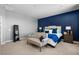 Well decorated bedroom with accent wall and a cozy sitting area at 3042 Echoed Rondel Ln, Henderson, NV 89044