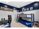 This room features a bunk bed and vibrant blue accent wall at 3042 Echoed Rondel Ln, Henderson, NV 89044