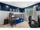 Fun bedroom featuring bunk beds and a vibrant blue accent wall at 3042 Echoed Rondel Ln, Henderson, NV 89044