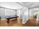 Bright game room featuring a billiard table, wood floors and natural light at 3042 Echoed Rondel Ln, Henderson, NV 89044