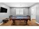 Spacious game room with billiard table, window shutters and TV at 3042 Echoed Rondel Ln, Henderson, NV 89044