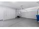 Spacious garage with epoxy flooring, ample storage cabinets, and an automatic door opener at 3042 Echoed Rondel Ln, Henderson, NV 89044