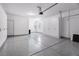 View of a spacious garage featuring epoxy flooring and built-in white storage cabinets at 3042 Echoed Rondel Ln, Henderson, NV 89044