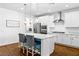 Bright kitchen features white cabinets, stainless steel appliances, and a stylish island with bar seating at 3042 Echoed Rondel Ln, Henderson, NV 89044