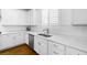 Clean, well-lit kitchen featuring white cabinets, stainless steel appliances, and a double sink at 3042 Echoed Rondel Ln, Henderson, NV 89044
