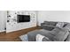 Cozy living room with a gray sectional sofa, media center, and built-in shelving at 3042 Echoed Rondel Ln, Henderson, NV 89044