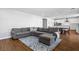 Wide shot of the open living space featuring a large sectional sofa with views into the kitchen and dining area at 3042 Echoed Rondel Ln, Henderson, NV 89044