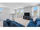 Upstairs loft area featuring a blue sectional, carpet, and windows with views at 3042 Echoed Rondel Ln, Henderson, NV 89044