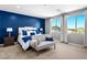 Stylish main bedroom featuring a tufted headboard, accent pillows, and abundant natural light at 3042 Echoed Rondel Ln, Henderson, NV 89044