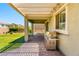 Outdoor covered patio with stainless steel grill, brick-laid ground, and picnic table overlooking backyard at 3042 Echoed Rondel Ln, Henderson, NV 89044