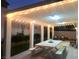 Inviting covered back patio with string lights, creating a cozy outdoor dining and entertaining space at 3329 Hidden Ridge St, Las Vegas, NV 89129