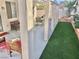 Backyard patio features artificial grass, covered area with stylish seating at 3329 Hidden Ridge St, Las Vegas, NV 89129