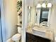 Bathroom featuring a vessel sink, stylish vanity, and a toilet with a decorative shelf at 3329 Hidden Ridge St, Las Vegas, NV 89129