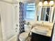 Well-lit bathroom featuring granite vanity with a vessel sink and shower with patterned curtain at 3329 Hidden Ridge St, Las Vegas, NV 89129