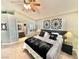 Cozy bedroom with a comfortable bed, decorative wall art, and a view into an en-suite bathroom at 3329 Hidden Ridge St, Las Vegas, NV 89129