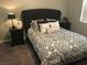 Bedroom showcasing a large headboard and coordinated bedside tables at 3329 Hidden Ridge St, Las Vegas, NV 89129
