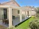Relaxing covered patio featuring overhead structure and manicured artificial grass at 3329 Hidden Ridge St, Las Vegas, NV 89129