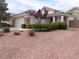 Single-story home with a well-maintained front yard, desert landscaping, and stone accents at 3329 Hidden Ridge St, Las Vegas, NV 89129