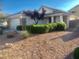Attractive home exterior with lush landscaping and a well-maintained yard at 3329 Hidden Ridge St, Las Vegas, NV 89129