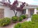 Charming home featuring a well-manicured front yard with lush greenery and decorative rock landscaping at 3329 Hidden Ridge St, Las Vegas, NV 89129