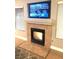 Cozy living room featuring a fireplace with tile surround and a mounted TV for entertainment at 3329 Hidden Ridge St, Las Vegas, NV 89129