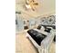 Comfortable main bedroom with a ceiling fan, decorative wall art, and a glimpse into the ensuite bathroom at 3329 Hidden Ridge St, Las Vegas, NV 89129