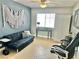 Functional office space featuring a sofa, desk, and ample lighting for a productive work environment at 3329 Hidden Ridge St, Las Vegas, NV 89129