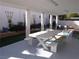Outdoor patio with a white picnic table and seating, plus landscaping with plants and greenery at 3329 Hidden Ridge St, Las Vegas, NV 89129