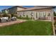 Lush backyard with manicured lawn, patio area, and seating for outdoor entertaining at 3430 Oristano Ln, Henderson, NV 89044