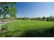 Expansive green lawn in a well-maintained community park with trees and walking paths at 3430 Oristano Ln, Henderson, NV 89044