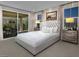 Serene primary bedroom with a sliding glass door, natural light, and neutral tones at 3430 Oristano Ln, Henderson, NV 89044