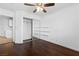 Bright bedroom features hardwood floors, ceiling fan, mirrored closet doors, and decorative shelves at 356 Clark Dr, Henderson, NV 89074