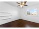 Inviting bedroom features hardwood floors, ceiling fan, modern plantation shutters, and decorative shelves at 356 Clark Dr, Henderson, NV 89074