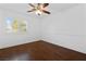 Bright bedroom featuring hardwood floors, ceiling fan, and plantation shutters allowing natural light at 356 Clark Dr, Henderson, NV 89074