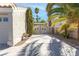 Long driveway leading to a gated entrance with a glimpse of the home and surrounding palm trees at 356 Clark Dr, Henderson, NV 89074