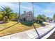 Well-manicured front yard with palm trees, and a two-story home with a driveway at 356 Clark Dr, Henderson, NV 89074