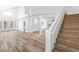 Open-concept living area with wood-look floors, high ceilings, and a staircase at 356 Clark Dr, Henderson, NV 89074