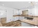 Well-lit kitchen with granite countertops, white cabinets, and modern appliances at 356 Clark Dr, Henderson, NV 89074