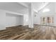Large living room featuring tall ceilings, wood-look floors, and access to the backyard at 356 Clark Dr, Henderson, NV 89074