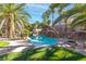 Resort style rock pool surrounded by lush landscaping and mature palm trees at 356 Clark Dr, Henderson, NV 89074