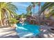 Resort style rock pool surrounded by lush landscaping and palm trees at 356 Clark Dr, Henderson, NV 89074