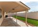Spacious covered back patio features brick and concrete tile flooring and lawn area at 368 Legacy Dr, Henderson, NV 89014