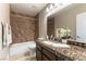 Well-appointed bathroom featuring granite counters, wood cabinets and tiled shower at 368 Legacy Dr, Henderson, NV 89014