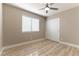 Bright bedroom featuring wood floors, a ceiling fan and closet space at 368 Legacy Dr, Henderson, NV 89014