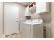 Well-lit laundry room features washer, dryer, storage cabinets, and vinyl flooring at 368 Legacy Dr, Henderson, NV 89014