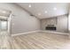 Bright living room featuring wood-look flooring, recessed lights and modern fireplace feature at 368 Legacy Dr, Henderson, NV 89014